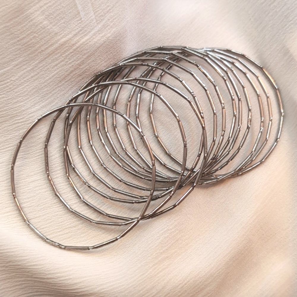 Stack of 12 solid metallic silver bangles